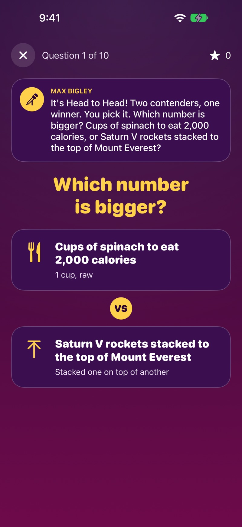 A question in progress, Question 1 of 10. Max Bigley’s caption reads “It’s Head to Head! Two contenders, one winner. You pick it. Which number is bigger? Cups of spinach to eat 2,000 calories, or Saturn V rockets stacked to the top of Mount Everest?” Below the heading “Which number is bigger?” are two cards, “Cups of spinach to eat 2,000 calories, 1 cup, raw” and “Saturn V rockets stacked to the top of Mount Everest, stacked one on top of another”, with VS between them.